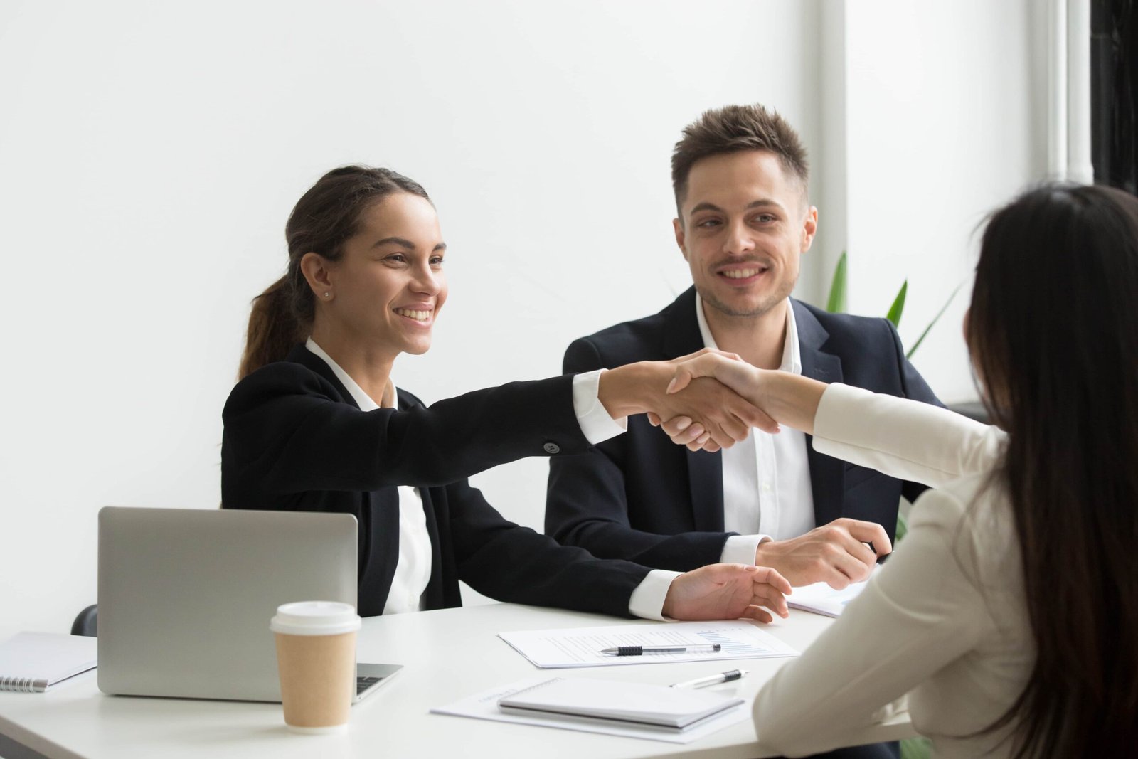 hr representatives positively greeting female job candidate min scaled